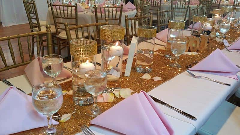 A long candlelit table set for dinner
